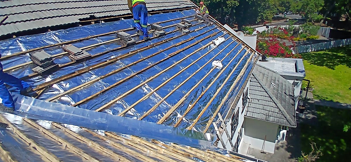 Roofers laying new underlay and battens during a full reroof in Cape Town